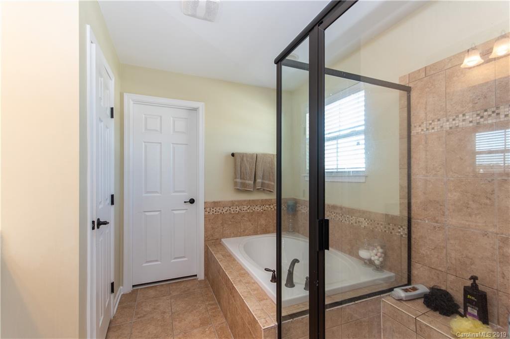 10937 Tailwater Street Davidson, NC 28036 - Photo 18 of 34 a bathroom with a tub shower and sink
