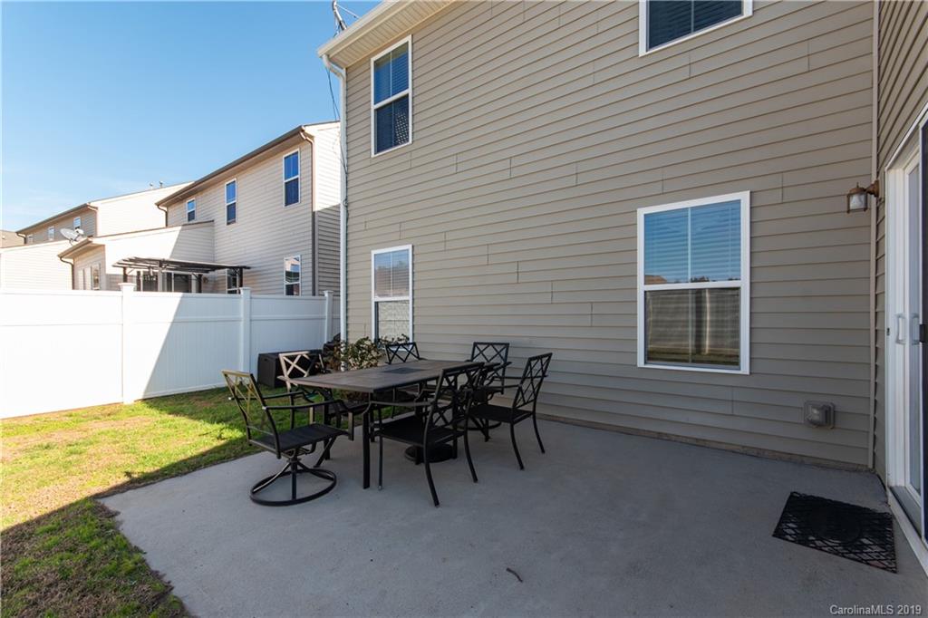 10937 Tailwater Street Davidson, NC 28036 - Photo 25 of 34 a view of a patio with table and chairs and wooden floor