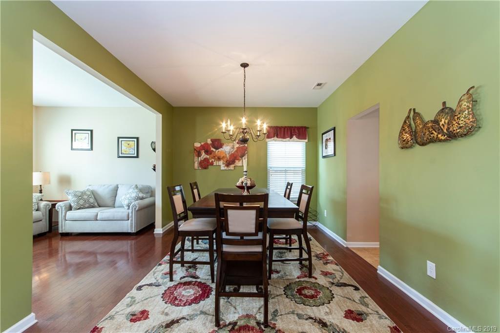 10937 Tailwater Street Davidson, NC 28036 - Photo 5 of 34 a view of a dining room with furniture and wooden floor