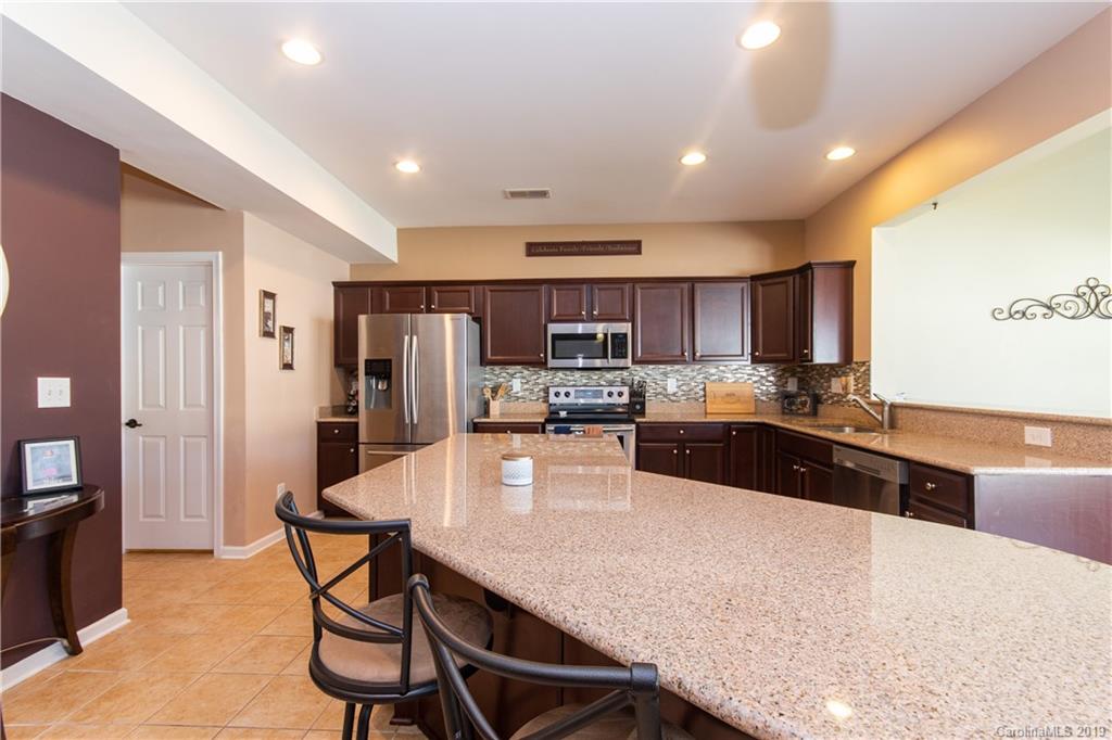 10937 Tailwater Street Davidson, NC 28036 - Photo 8 of 34 a large kitchen with a table and chairs