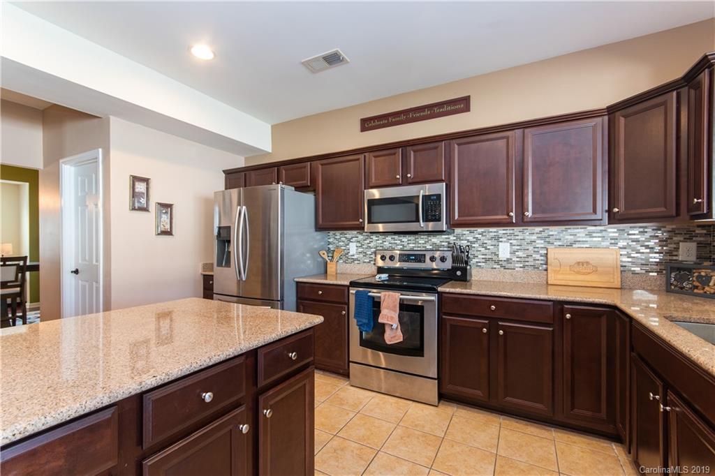 10937 Tailwater Street Davidson, NC 28036 - Photo 9 of 34 a kitchen with a sink stove and refrigerator
