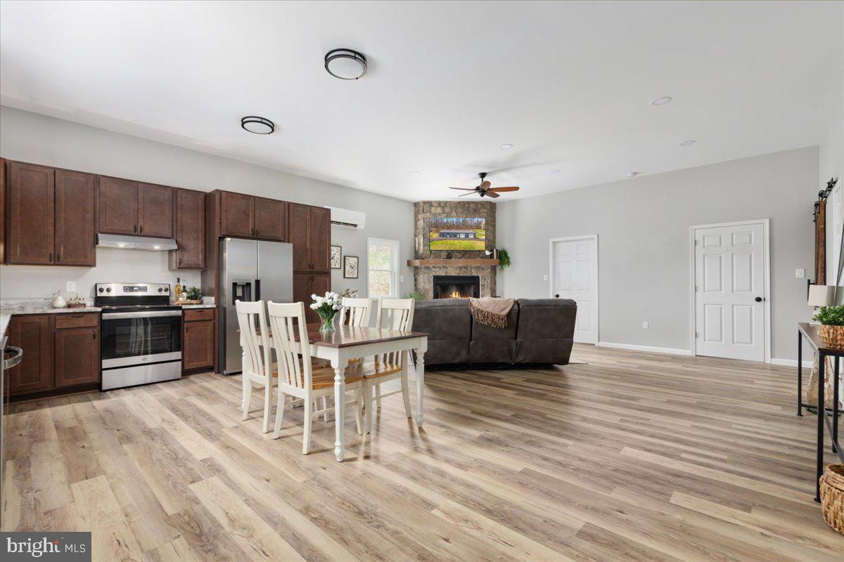 5331 Merry Oaks Road The Plains, VA 20198 - Photo 12 of 54 a living room with stainless steel appliances furniture wooden floor and a kitchen view