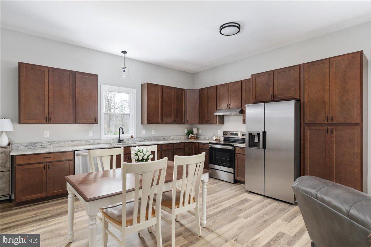 5331 Merry Oaks Road The Plains, VA 20198 - Photo 10 of 54 a kitchen with stainless steel appliances granite countertop a refrigerator a sink a stove a dining table and chairs