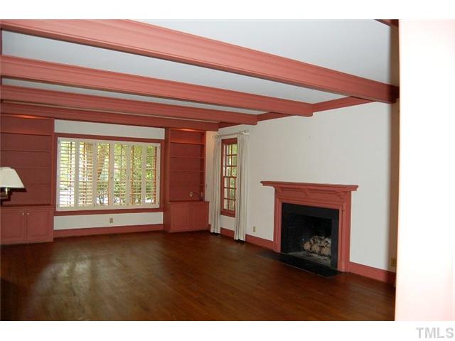 815 Marlowe Road, Unit 1 Raleigh, NC 27609 - Photo 7 of 22 a view of an empty room with wooden floor fireplace and a window