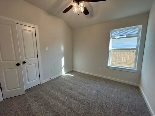 an empty room with a empty space and a ceiling fan