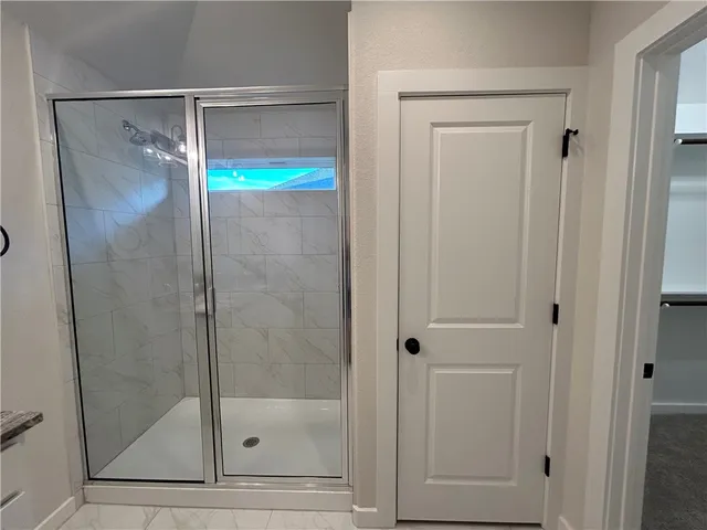 a bathroom with a glass shower door