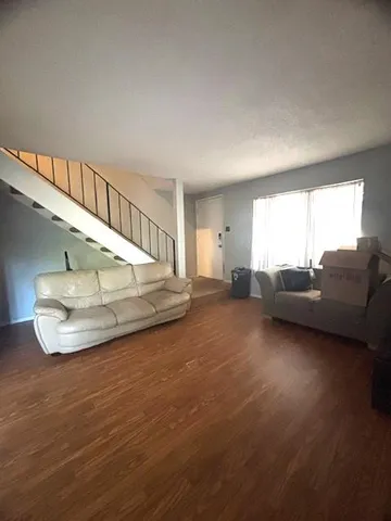 a living room with furniture and a floor to ceiling window