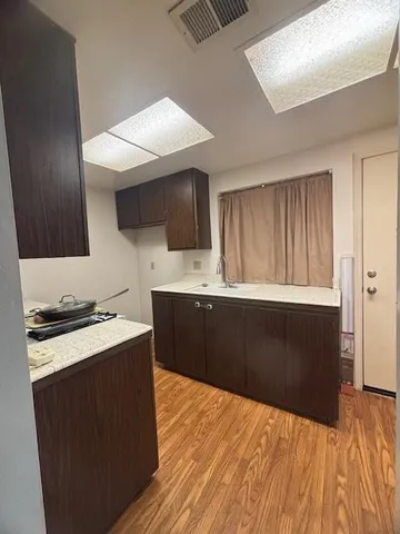 a kitchen with a stove a sink and a microwave