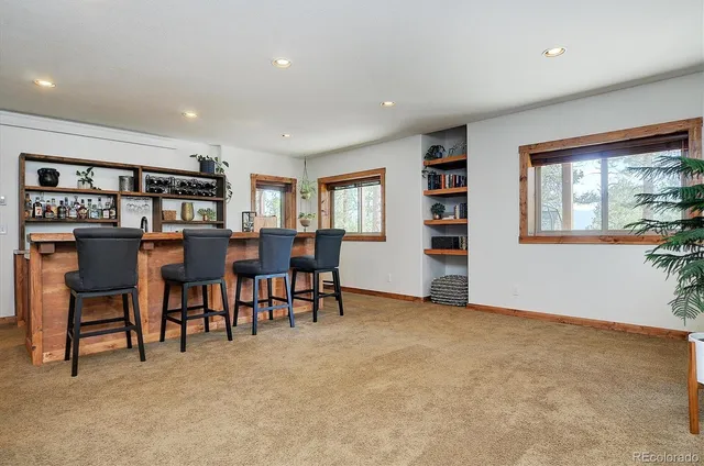 a balcony with furniture and wooden floor