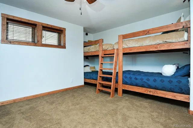 a bedroom with a bed dresser and window