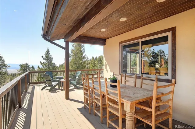 a view of a chair and table on the deck