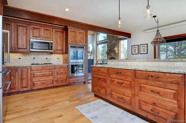 a living room with fireplace furniture and a large window