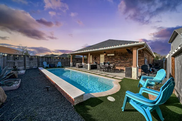a view of a house with backyard porch and sitting area