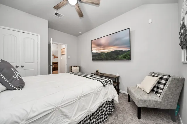 a bedroom with a bed and a flat screen tv