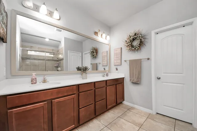 a bathroom with a double vanity sink and a mirror