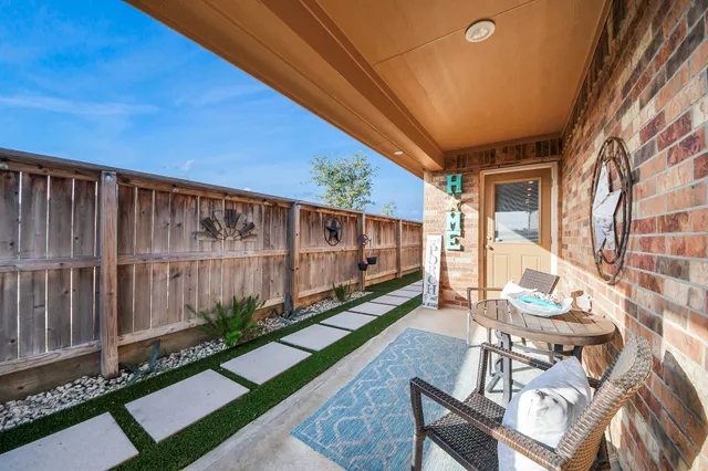 a view of an chairs and table in the patio