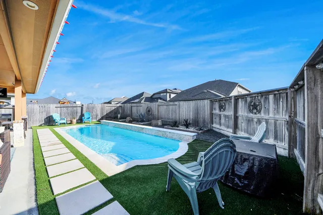 a backyard of a house with table and chairs