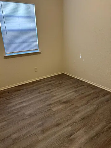 an empty room with wooden floor