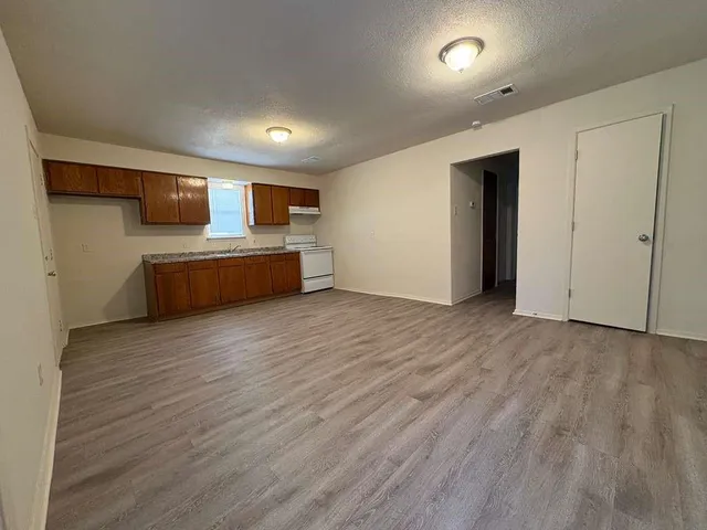 a view of room with wooden floor