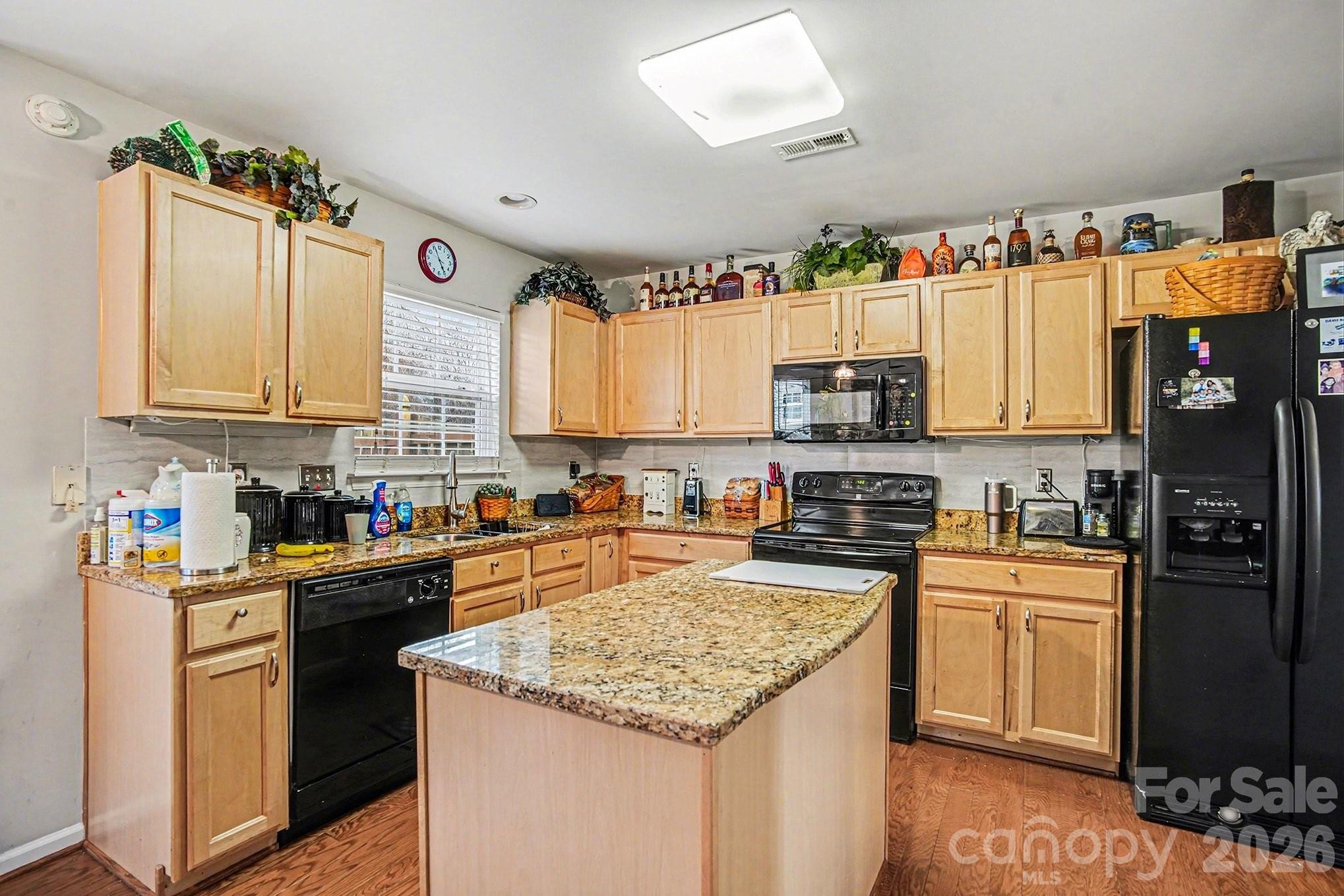5625 Davis Ridge Drive Charlotte, NC 28269 - Photo 11 of 27 a kitchen with granite countertop a refrigerator stove top oven a sink and dishwasher