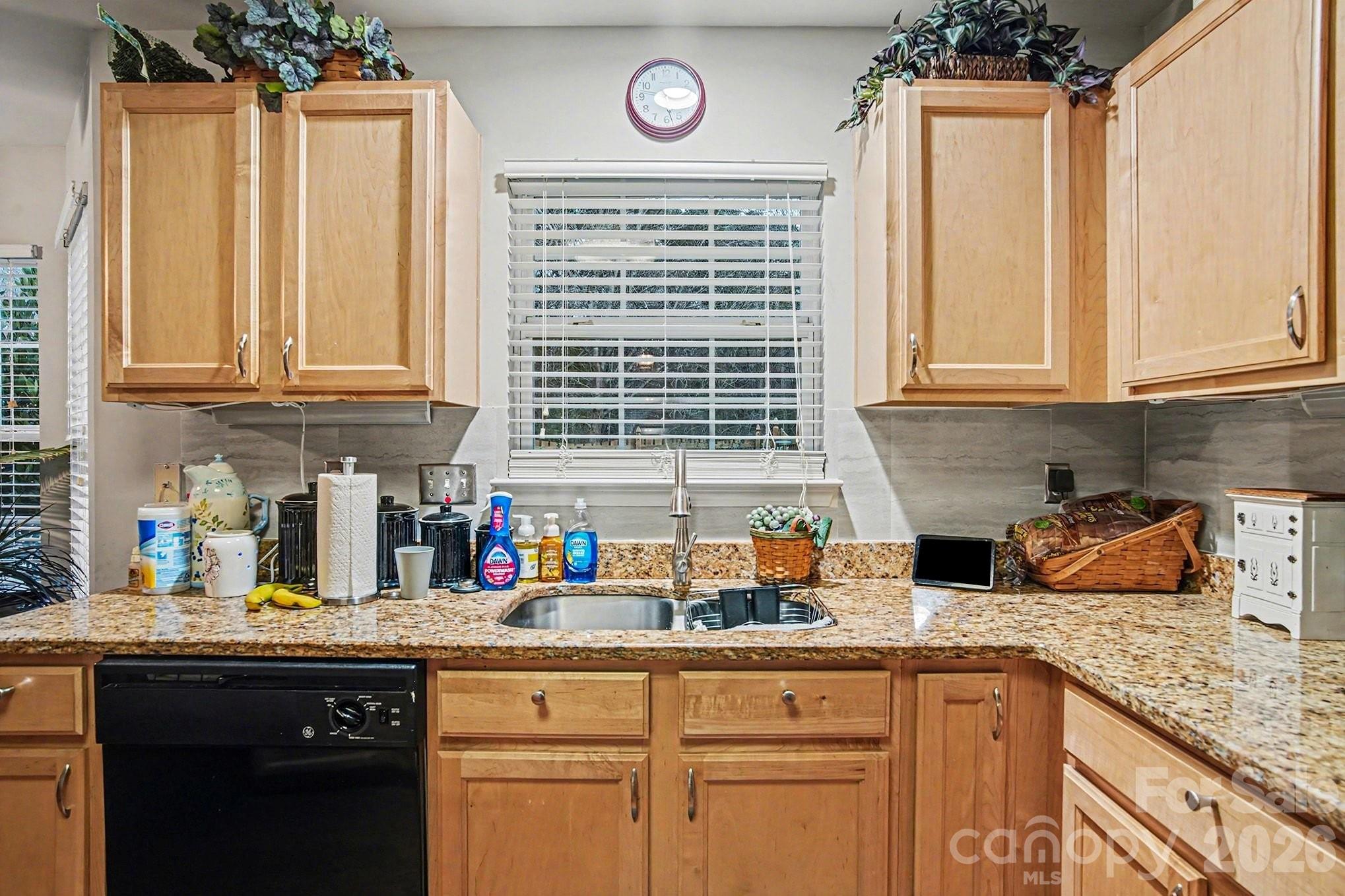 5625 Davis Ridge Drive Charlotte, NC 28269 - Photo 12 of 27 a kitchen with stainless steel appliances granite countertop a sink a stove and a wooden cabinets