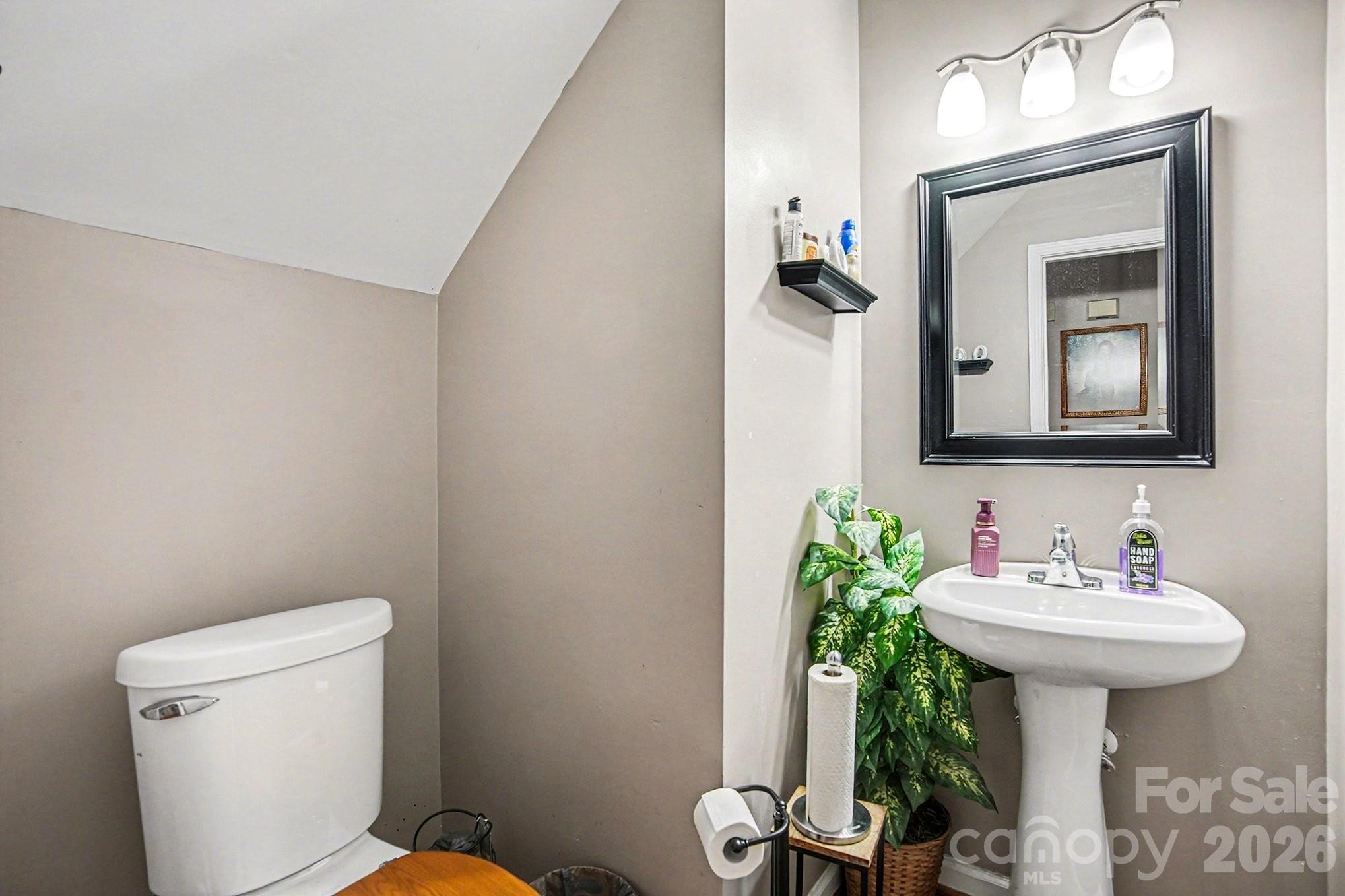 5625 Davis Ridge Drive Charlotte, NC 28269 - Photo 17 of 27 a bathroom with a toilet sink and mirror