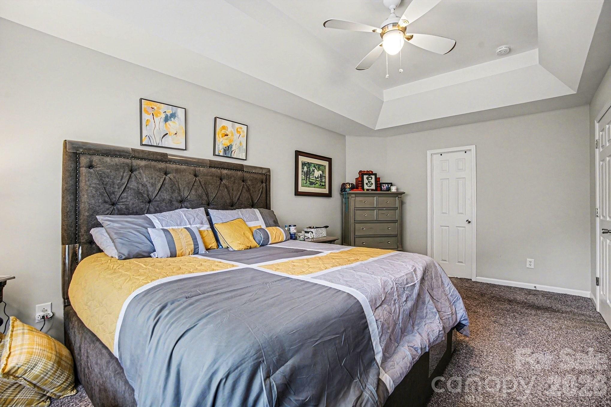 5625 Davis Ridge Drive Charlotte, NC 28269 - Photo 19 of 27 a bedroom with a bed and a chandelier