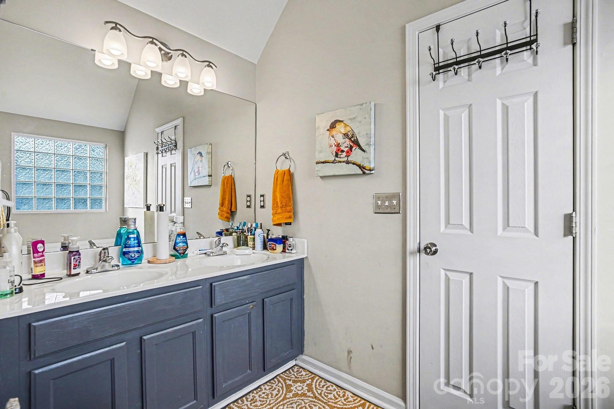5625 Davis Ridge Drive Charlotte, NC 28269 - Photo 21 of 27 a bathroom with a sink mirror and a shower