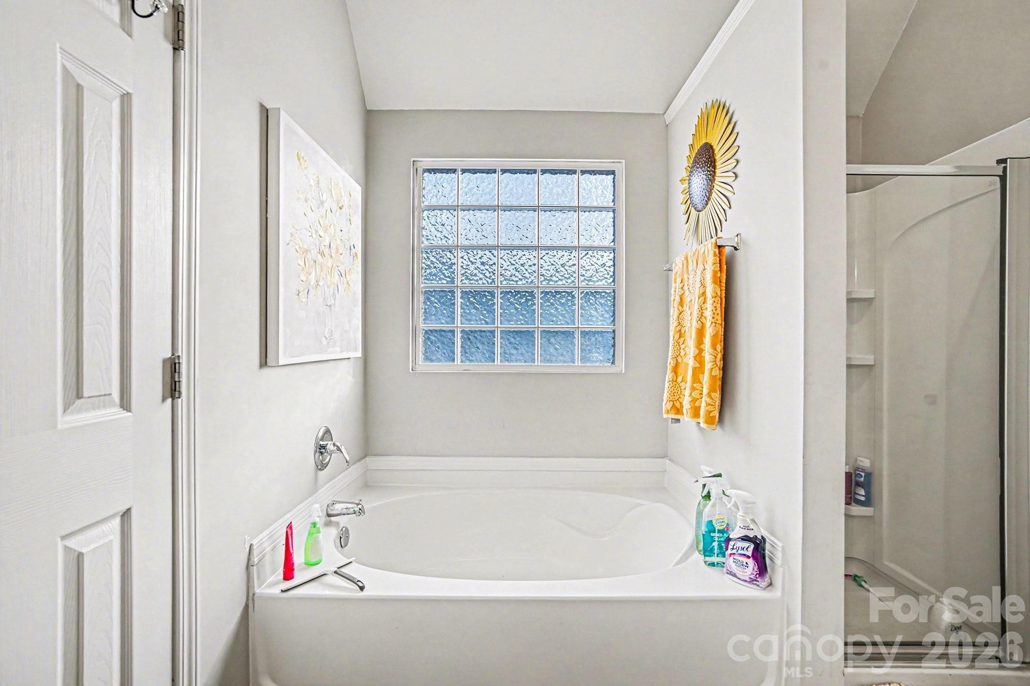 5625 Davis Ridge Drive Charlotte, NC 28269 - Photo 22 of 27 a bathroom with a bathtub and a shower