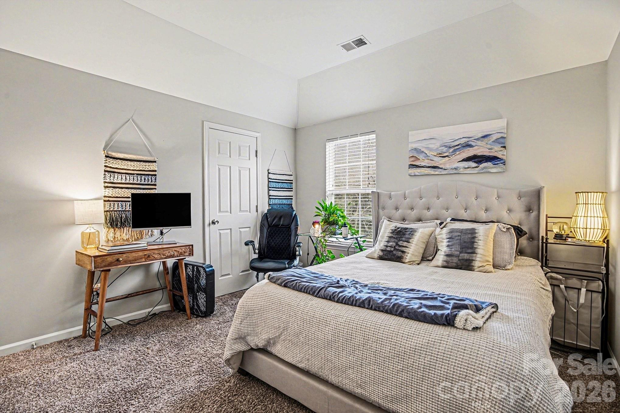 5625 Davis Ridge Drive Charlotte, NC 28269 - Photo 23 of 27 a bedroom with a bed and a flat screen tv