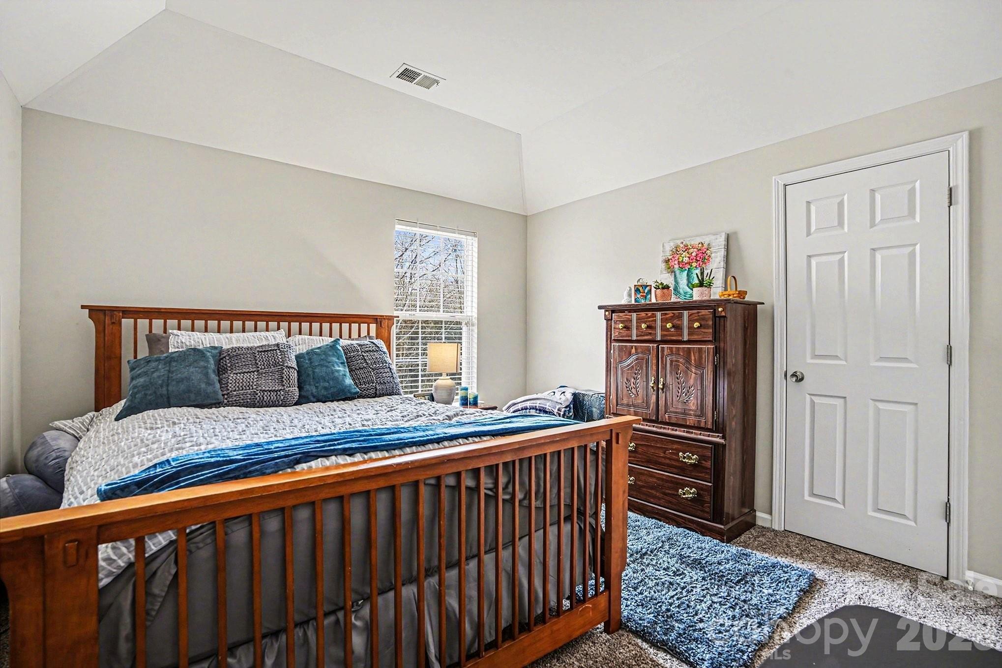 5625 Davis Ridge Drive Charlotte, NC 28269 - Photo 24 of 27 a bedroom with a bed and wooden floor