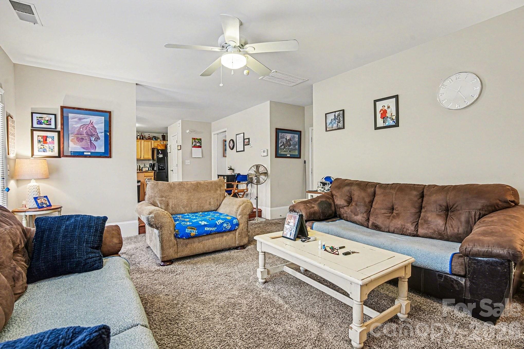 5625 Davis Ridge Drive Charlotte, NC 28269 - Photo 3 of 27 a living room with furniture a couch and paintings on the wall