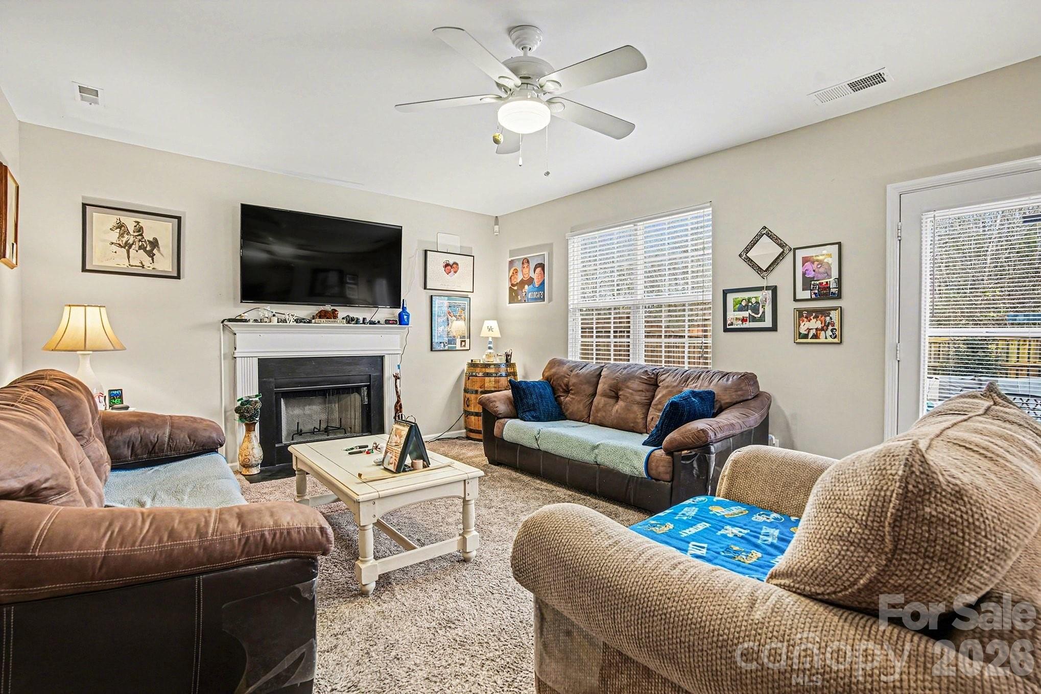 5625 Davis Ridge Drive Charlotte, NC 28269 - Photo 5 of 27 a living room with furniture fireplace and a flat screen tv