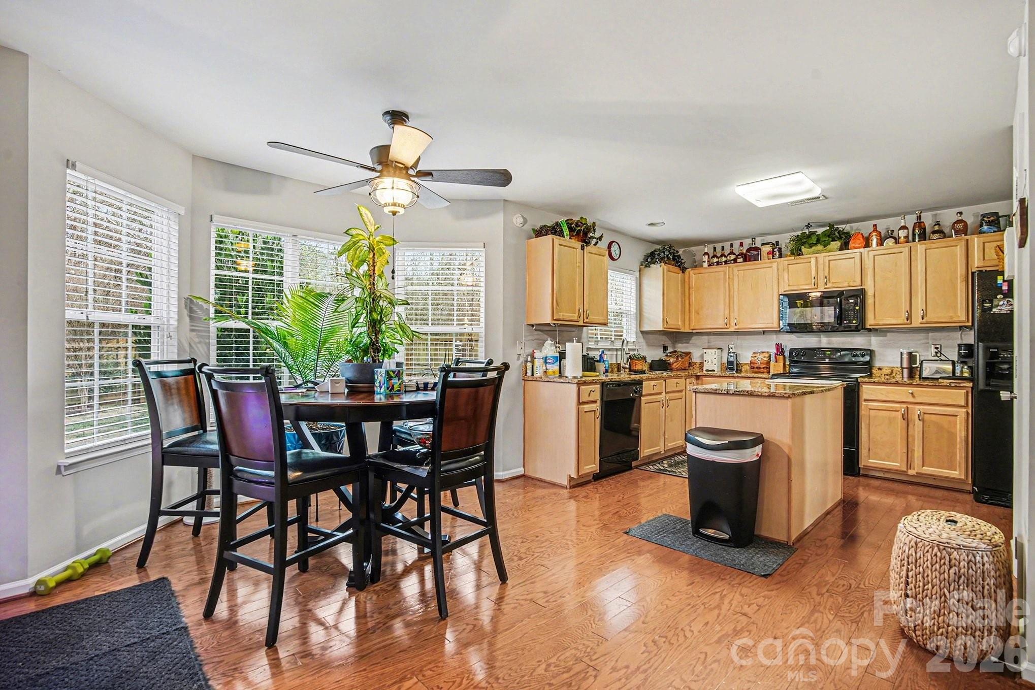 5625 Davis Ridge Drive Charlotte, NC 28269 - Photo 8 of 27 a kitchen with a table chairs microwave and cabinets