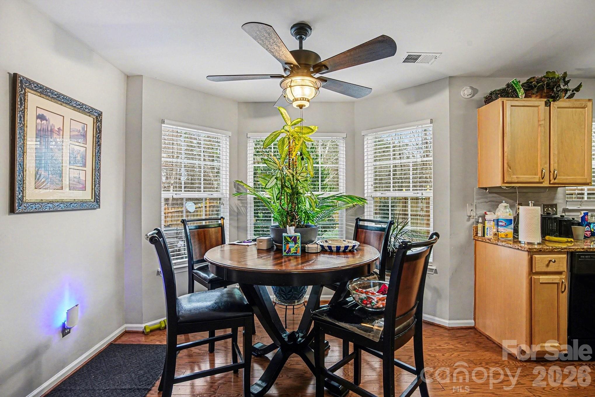 5625 Davis Ridge Drive Charlotte, NC 28269 - Photo 9 of 27 a dining room with furniture a chandelier and a rug