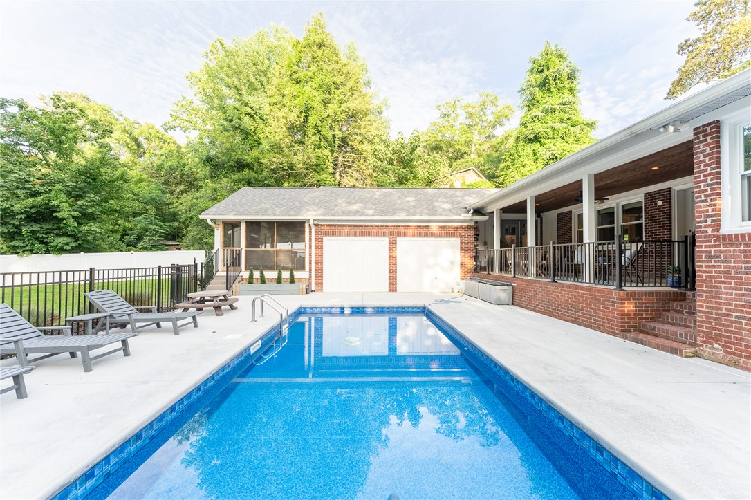 103 Riggs Drive Clemson, SC 29631 - Photo 33 of 50 An inviting backyard oasis offers a sparkling in-ground pool and ample space for outdoor enjoyment.