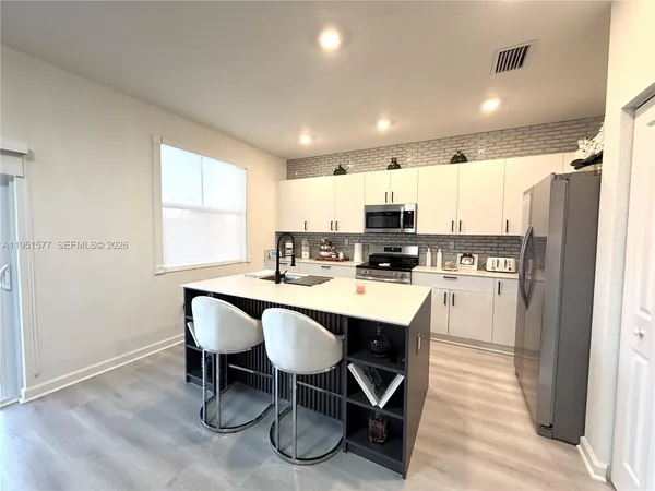 a kitchen with a sink and a refrigerator