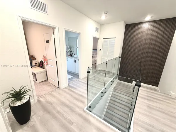 a kitchen with stainless steel appliances kitchen island granite countertop a sink a stove and white cabinets