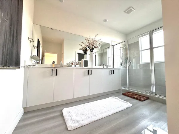 a bathroom with a tub sink and mirror