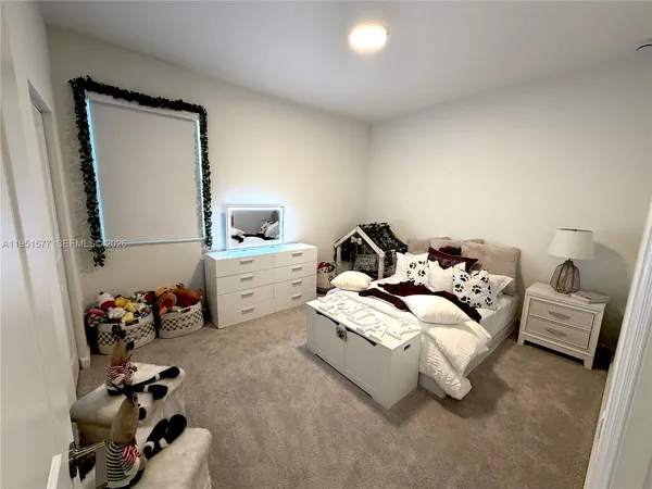 a bedroom with a bed and a couch