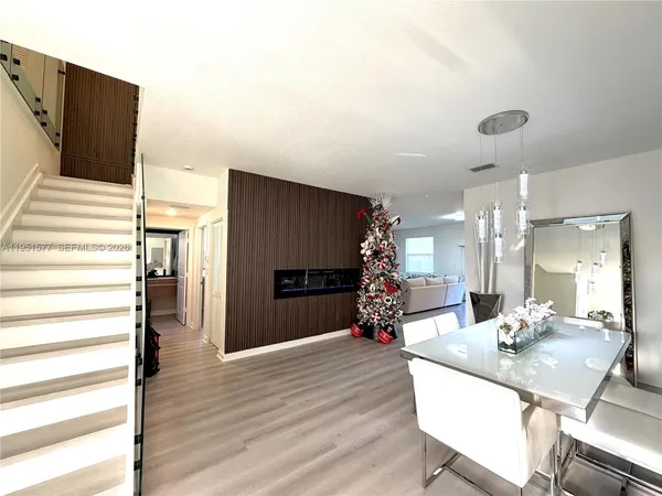 a view of a dining room with furniture and wooden floor