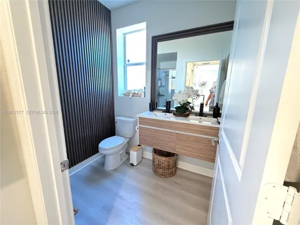 a bathroom with a sink toilet a mirror and shower