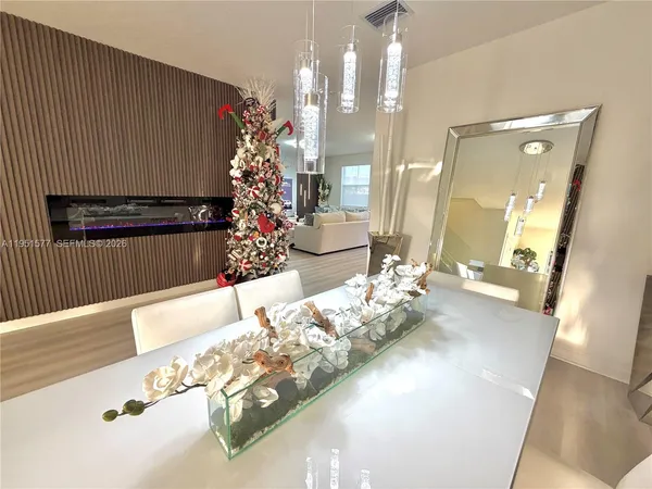 a living room with dining room and wooden floor