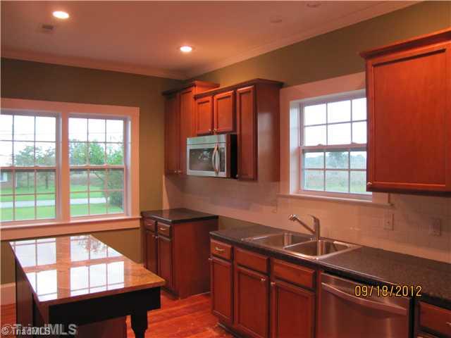 3635 Smithtown Road East Bend, NC 27018 - Photo 4 of 13 Kitchen. Beautiful new Kitchen; quite an update from the 1920 s. Includes: custom cabinets, smooth counters, tile backsplash, granite top island for more work space or eat at island. Hardwood Floors.