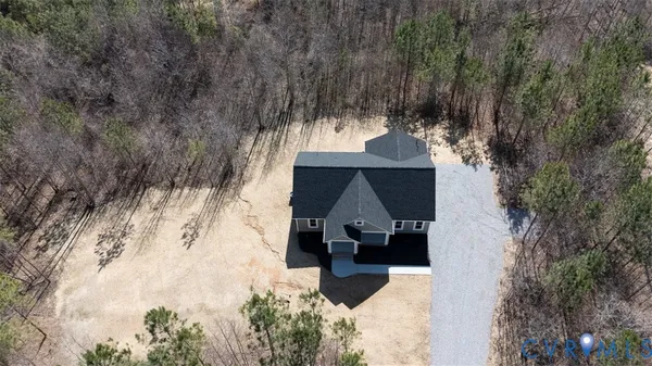 an aerial view of a house with a yard