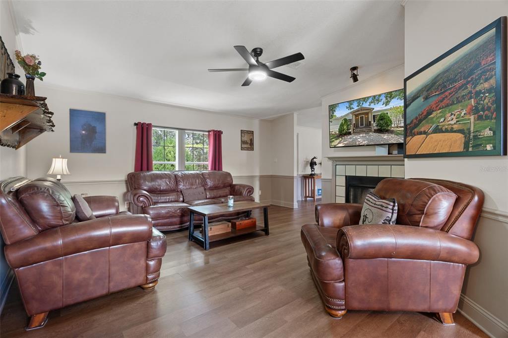 26255 Lambeth Road Brooksville, FL 34601 - Photo 25 of 76 a living room with furniture a fireplace and a flat screen tv
