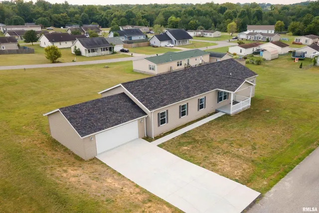 an aerial view of a house with a yard