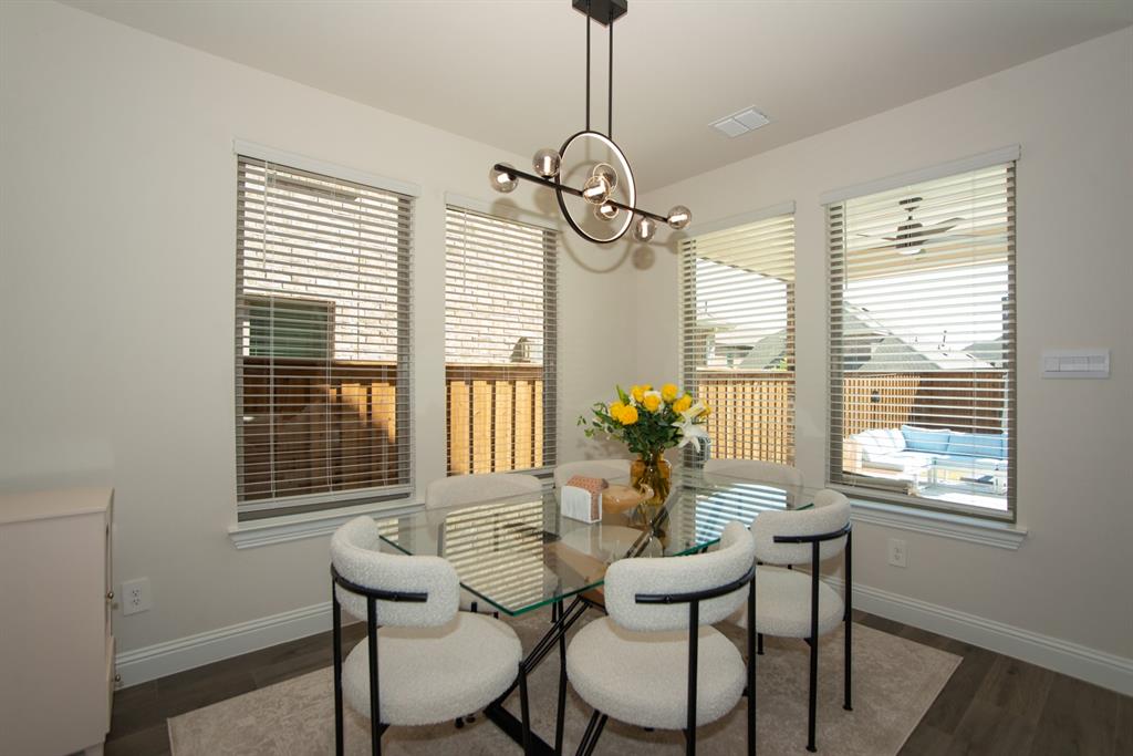 3813 Oldham Road Little Elm, TX 75068 - Photo 11 of 27 Dining room featuring suspended lighting and dark wood finished floors