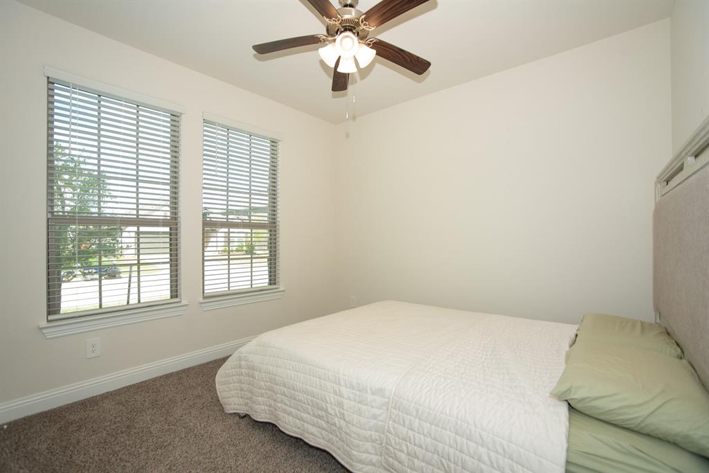3813 Oldham Road Little Elm, TX 75068 - Photo 12 of 27 Carpeted bedroom featuring a ceiling fan and baseboards
