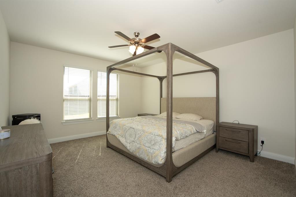 3813 Oldham Road Little Elm, TX 75068 - Photo 15 of 27 Carpeted bedroom featuring baseboards and ceiling fan